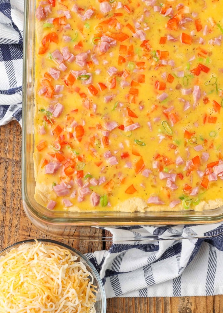 The casserole has been fully assembled in a clear glass baking dish and is ready to bake!