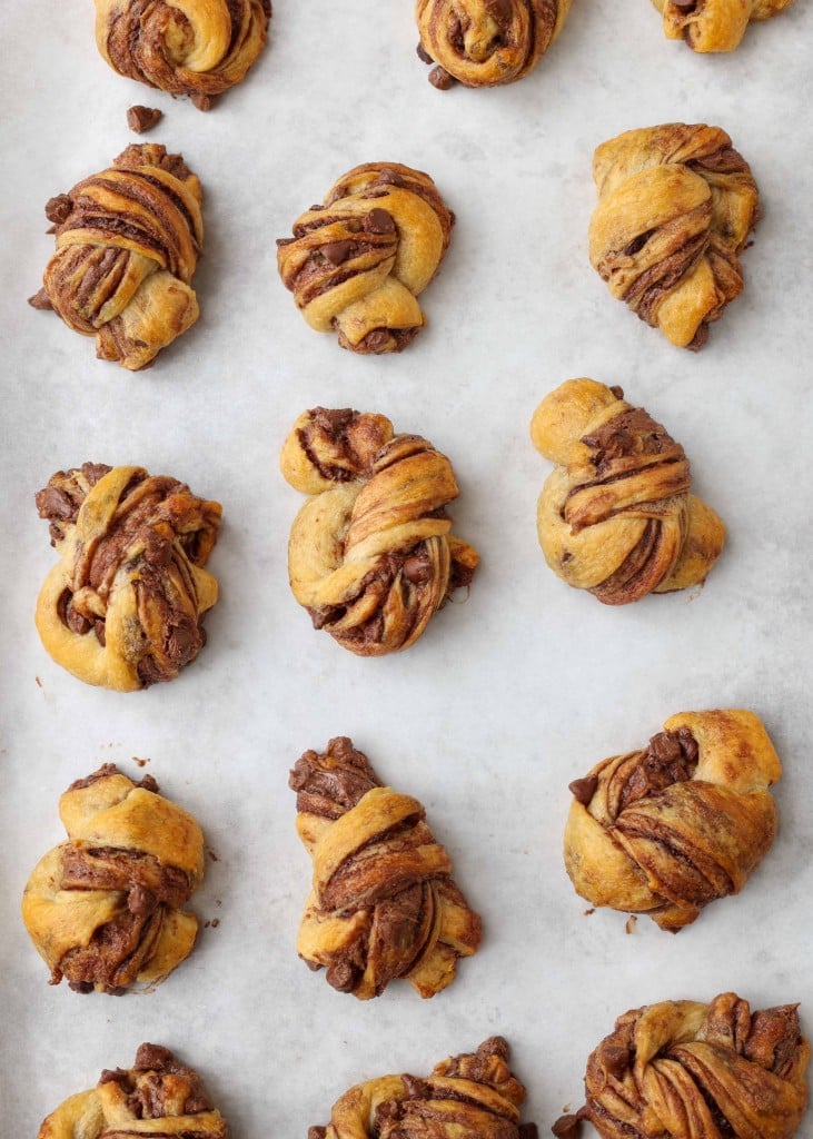 Overhead vertical shot of chocolate babka bites on a sheet pan lined with parchment paper