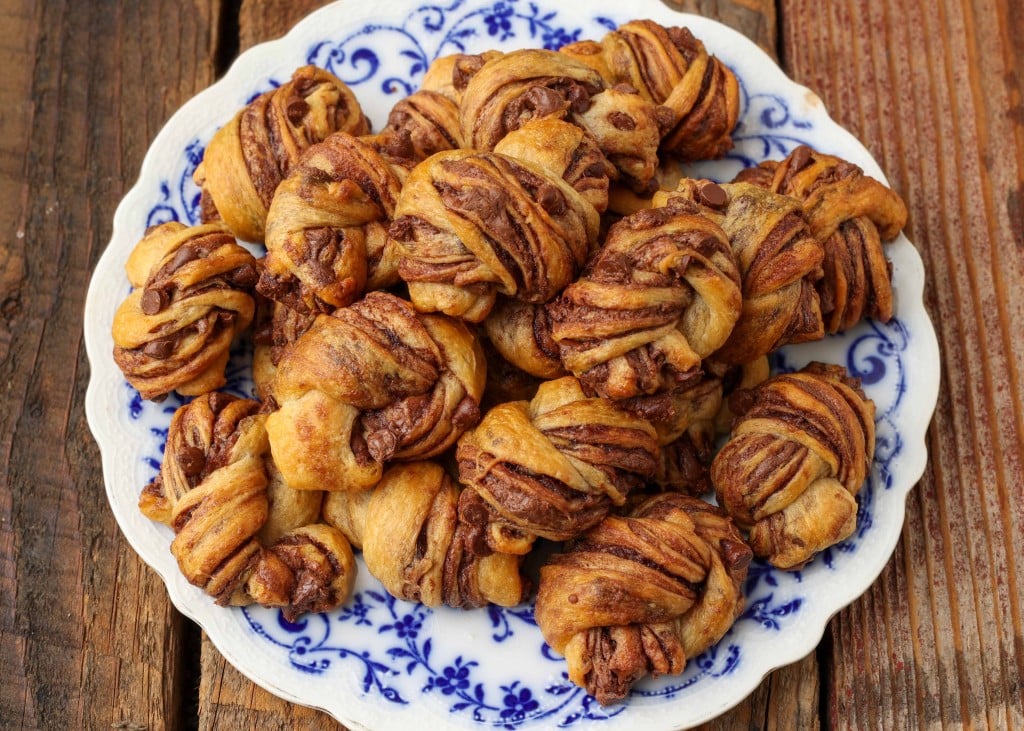 Overhead horizontal shot of chocolate babka bites, served in a white dish with blue floral print