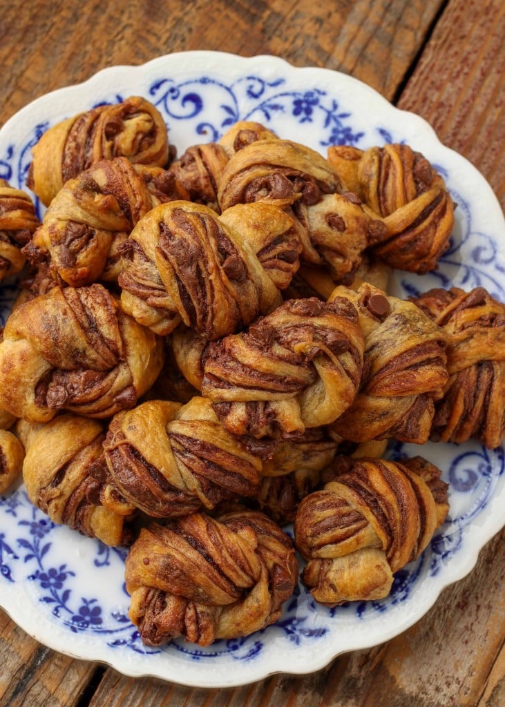 Overhead vertical shot of chocolate babka bites, served in a white dish with blue floral print