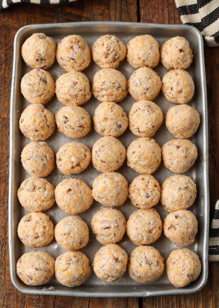 Ingredients shaped into balls and arranged in rows on sheet pan
