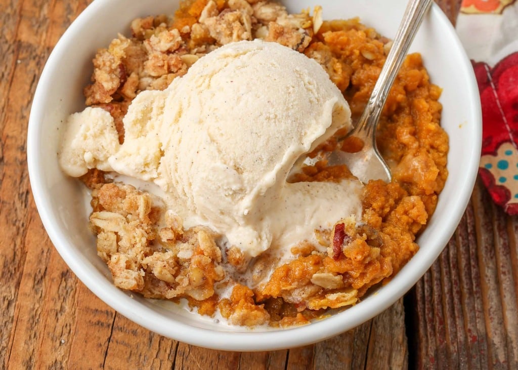 A bowl of pumpkin crisp topped with vanilla ice cream