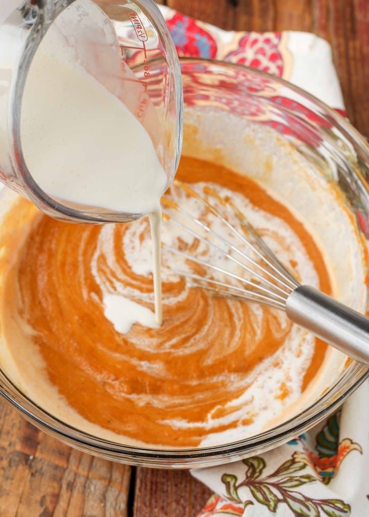 Pouring the cream over the pumpkin puree mixture.