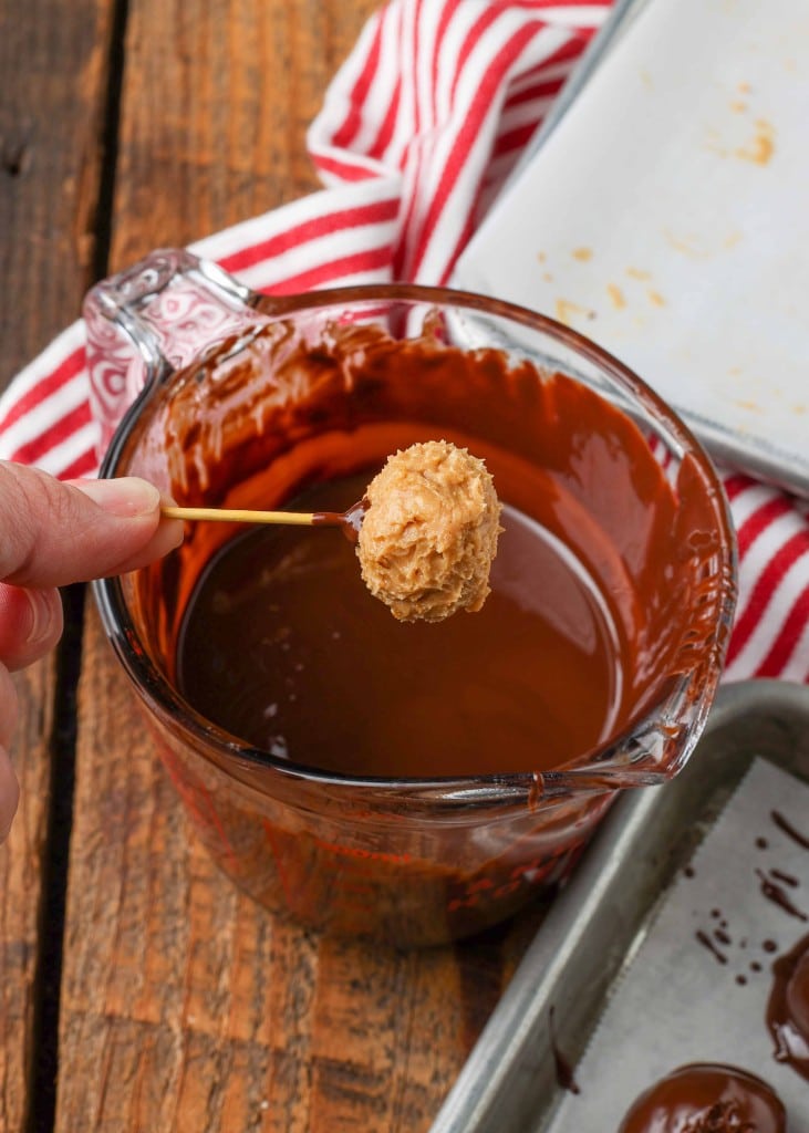 Preparing to dip Peanut Butter Ball into bowl of molten chocolate