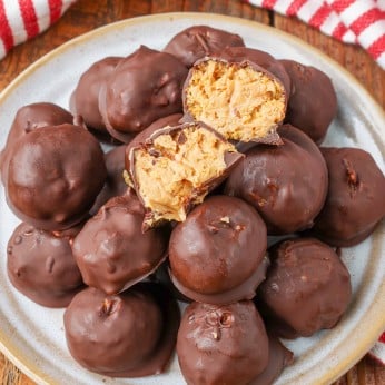 Peanut Butter Balls, chocolate covered with cornflakes, on small plate with striped napkin