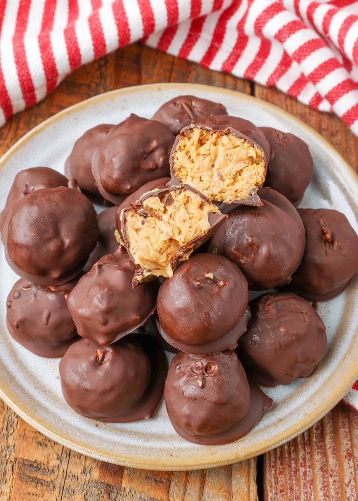 Peanut Butter Balls, chocolate covered with cornflakes, on small plate with striped napkin