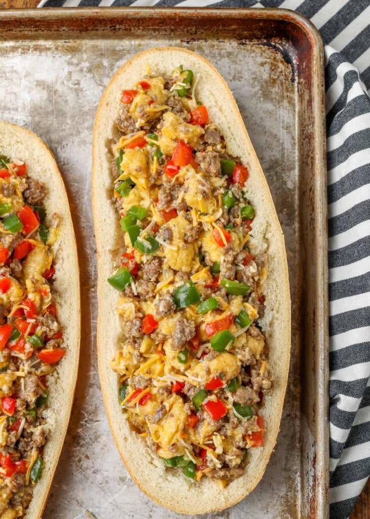 Sausage, eggs, bell peppers, onions, and shredded cheese in French bread