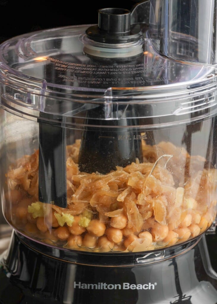 Chickpeas, garlic, and tahini in food processor