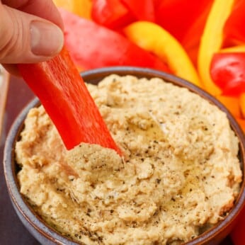 Dipping bell peppers in creamy hummus