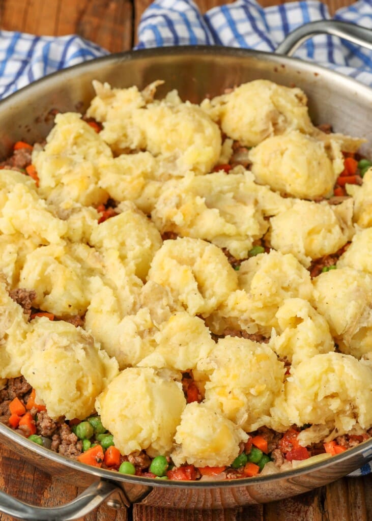 Scoops of potatoes over beef, peas, and carrots mixture