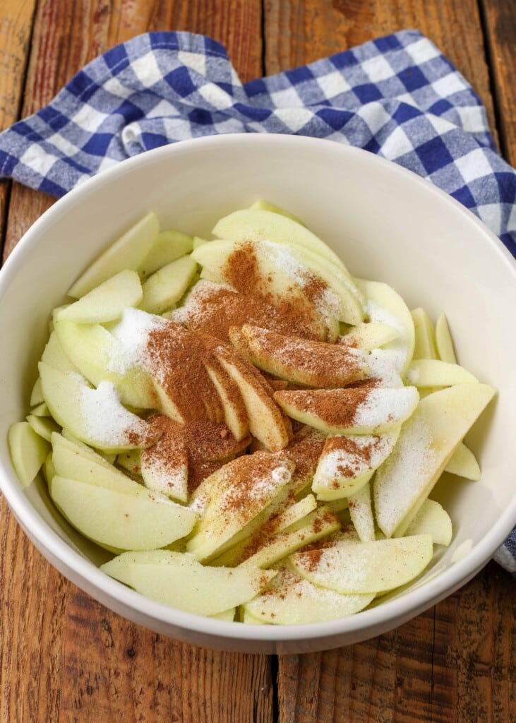 apples with sugar and spices in white bowl