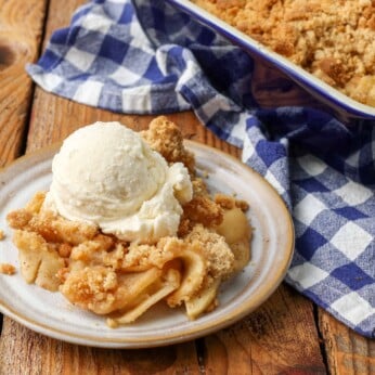 small pottery plate with scoop of ice cream and apple crisp