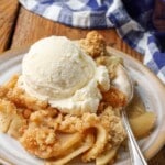 close up photo of apple crisp on plate with silver fork