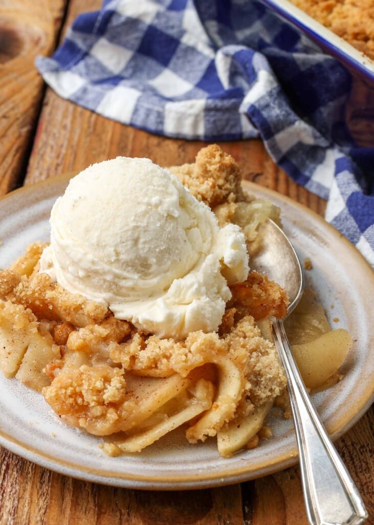 close up photo of apple crisp on plate with silver fork