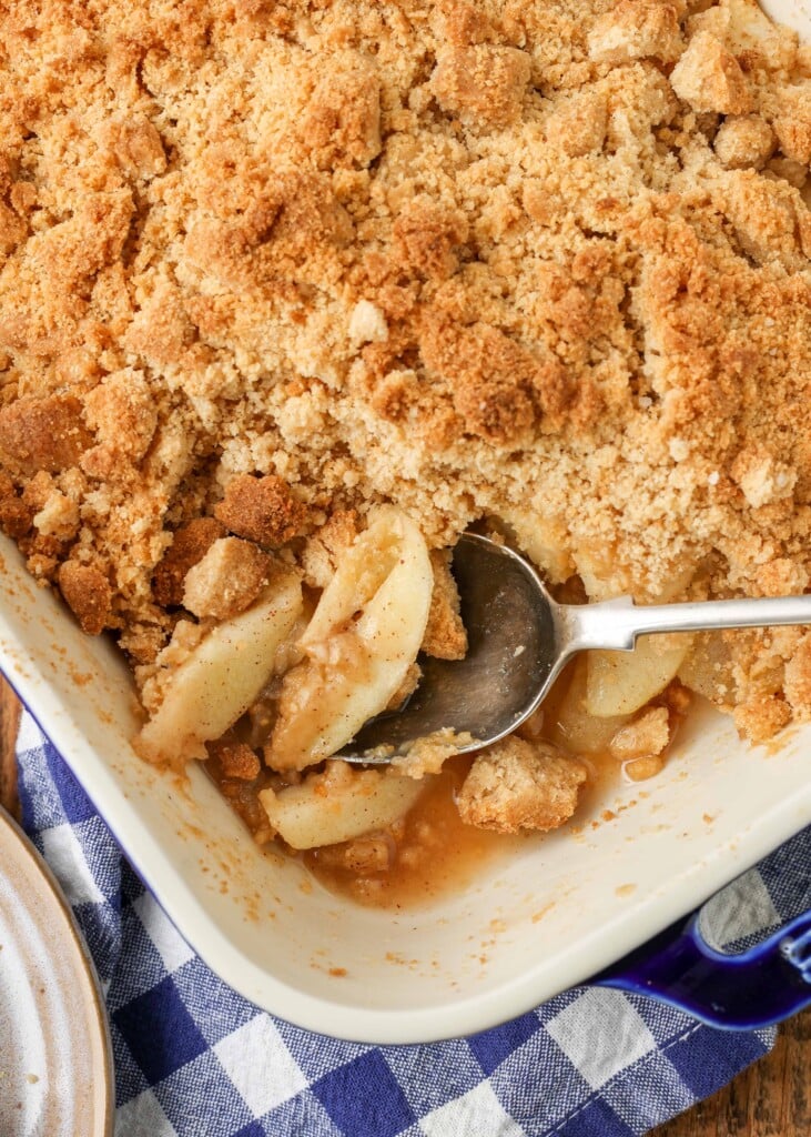 apple crisp in baking dish with serving spoon