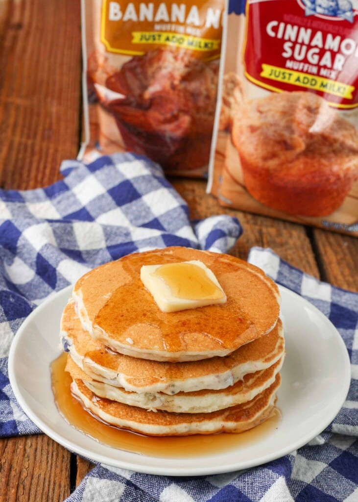 Pancakes stacked on plate with blue and white checkered towel
