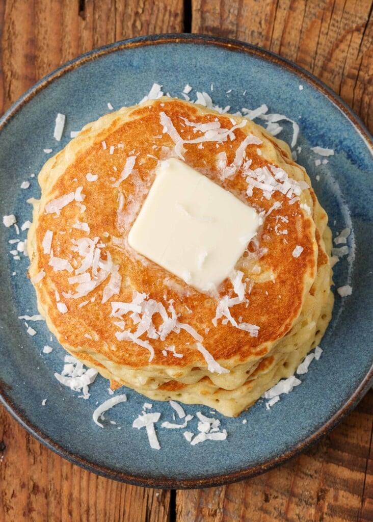 coconut sprinkled over stack of pancakes