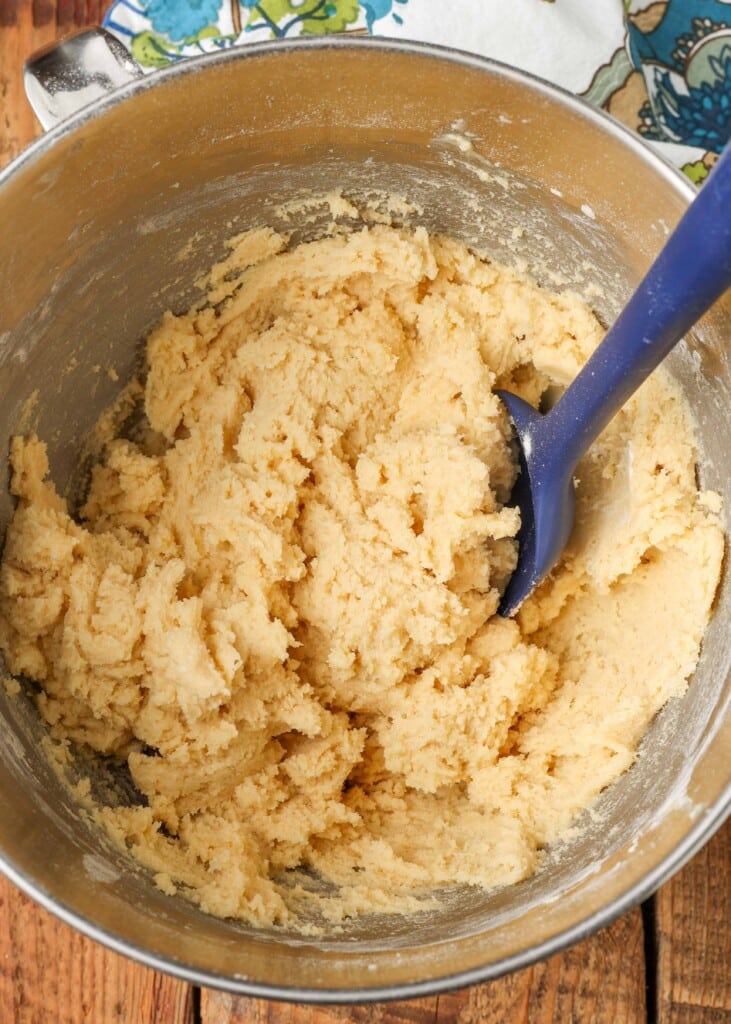 Stirring cookie dough in mixing bowl with spatula