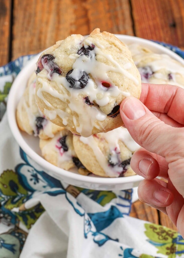 Hand holding glazed berry cookie