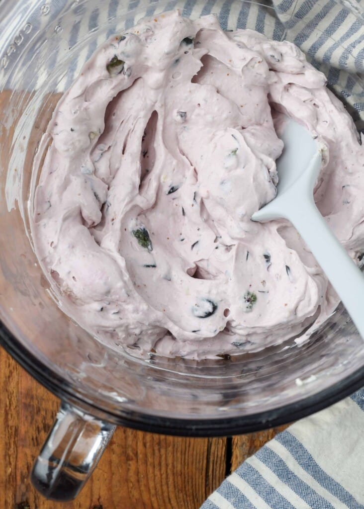 bowl of berry cream cheese with a spatula