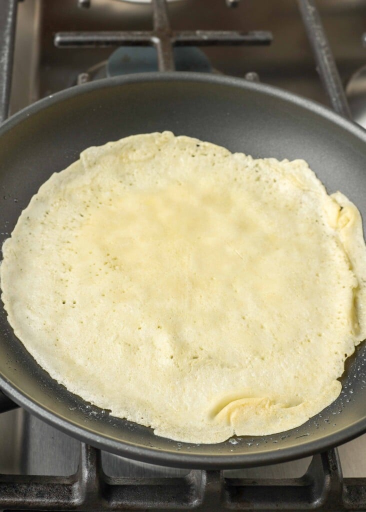 Thin pancake cooking in pan