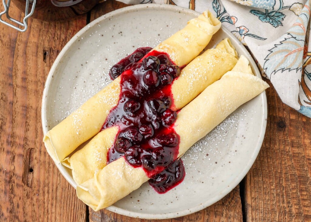 Rolled pancakes with blueberry compote