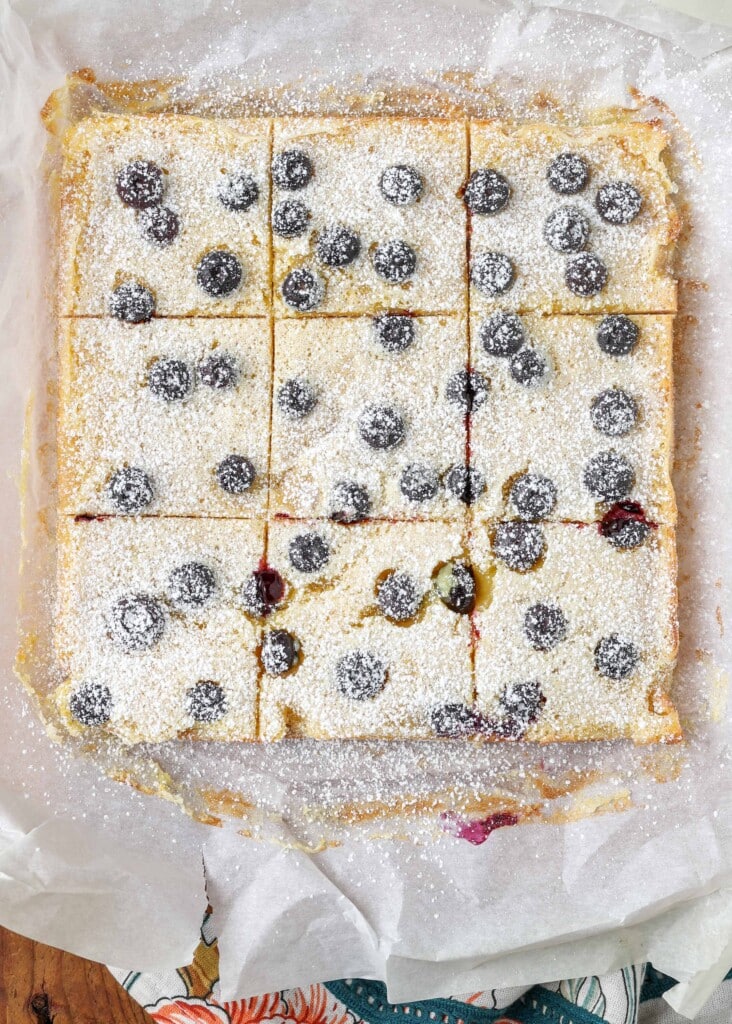 sliced lemon and blueberry bars on parchment paper