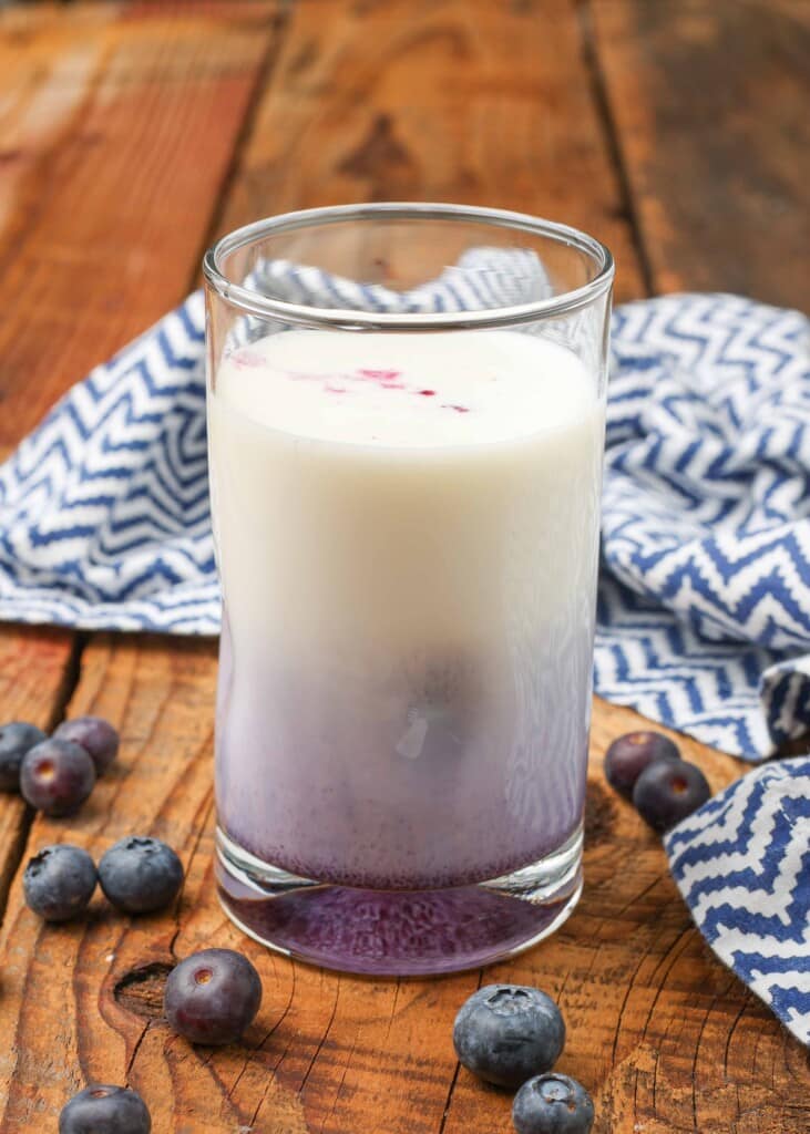 the colors are not yet mixed, lavender on the bottom and white on the top for the blueberry milk
