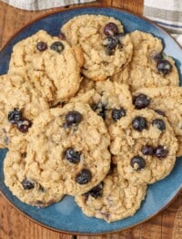 oatmeal cookies on a blue plate over a wooden tabletop