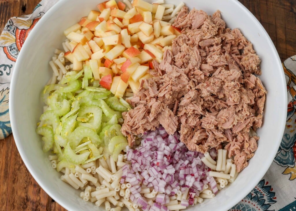 pasta salad ingredients with tuna, apple, celery, and onion