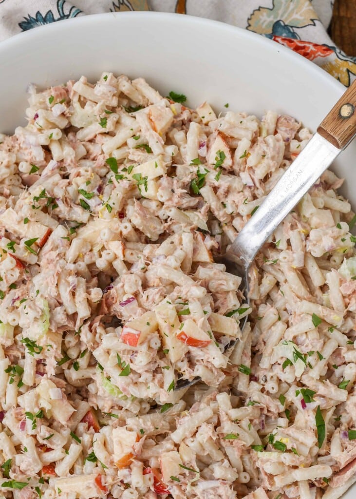 close up of a scoop of pasta salad with tuna and apple