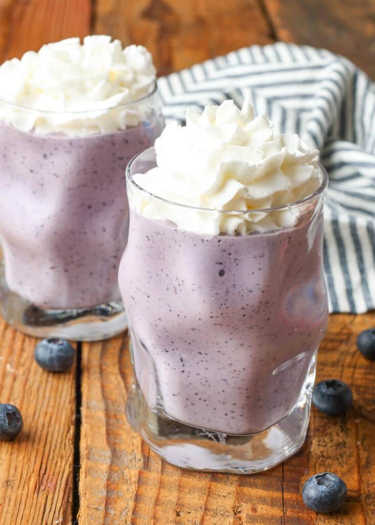 berry milkshake with whipped cream on top