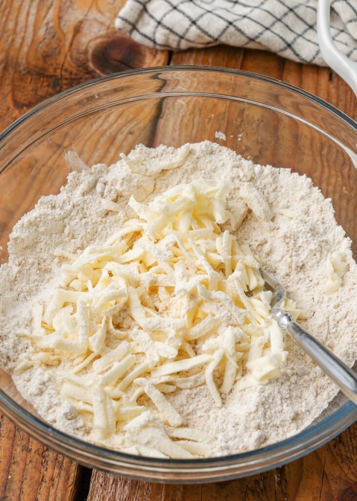 Grated butter and dry ingredients in glass bowl
