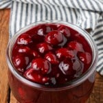 jar filled with cherry pie filling on wooden table