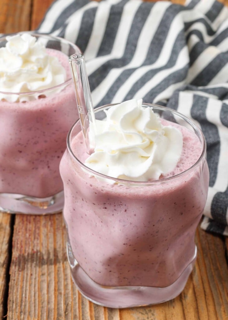 cherry ice cream shake in glass topped with whipped cream