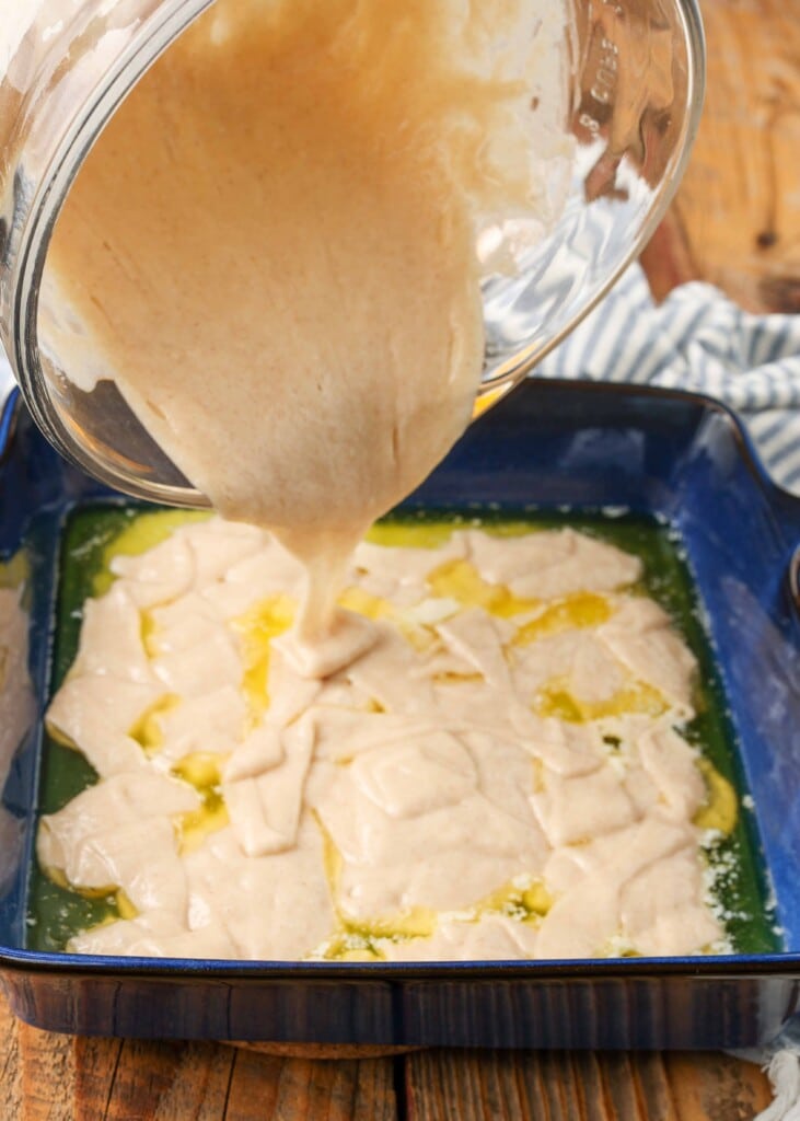 batter pouring into blue baking dish