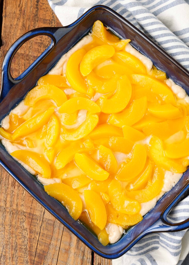 cobbler with peaches on top ready for the oven