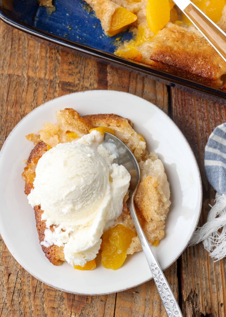 serving of cobbler on white plate with spoon