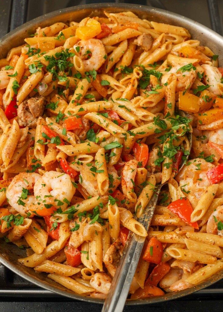 Overhead vertical shot of creamy pasta with shrimp and bell peppers