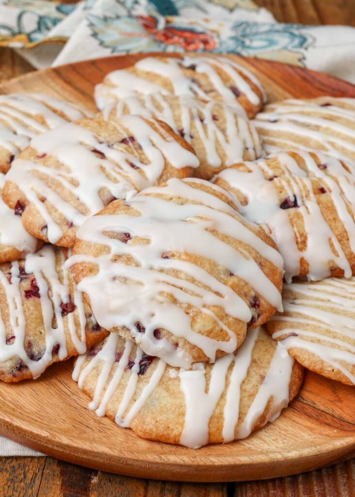 Soft cherry cookies on a rack over a pan with glaze drizzled over the top