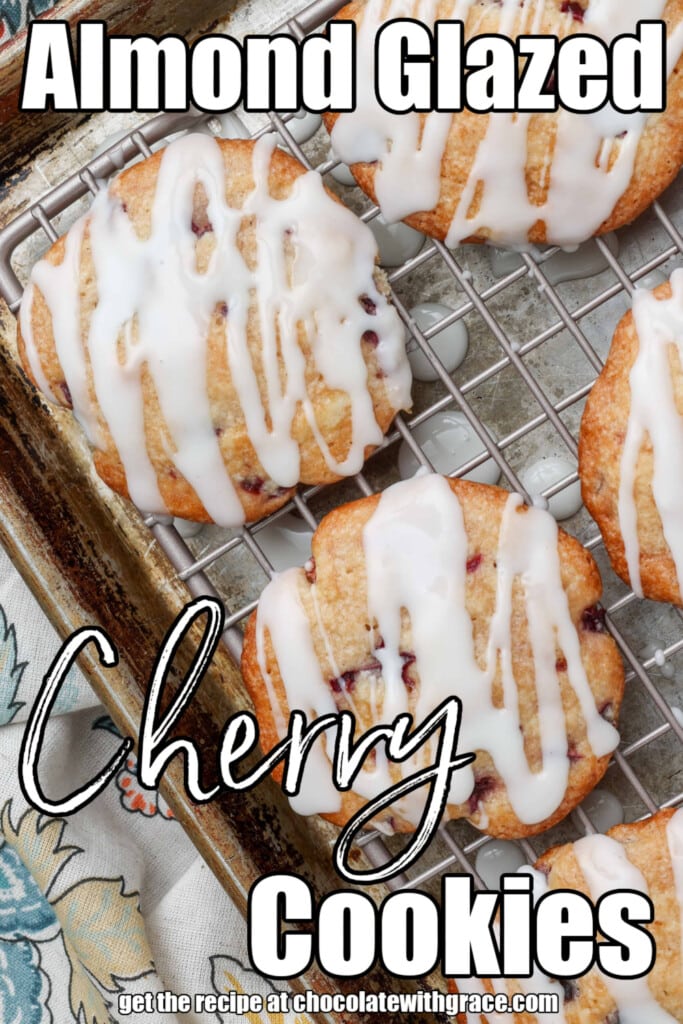 Soft cherry cookies on a rack over a pan with glaze drizzled over the top