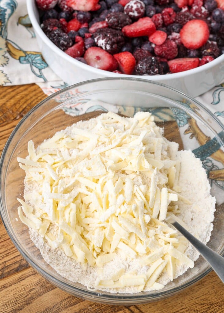 grated butter in bowl with flour