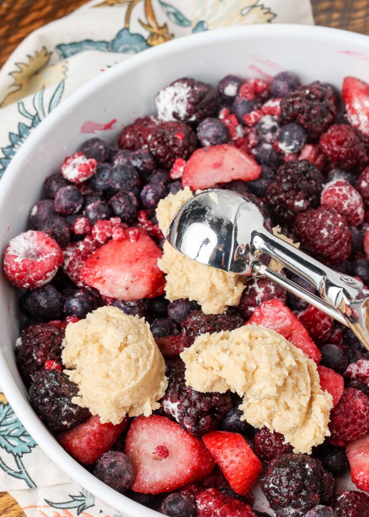 topping being dropped over fruit filling