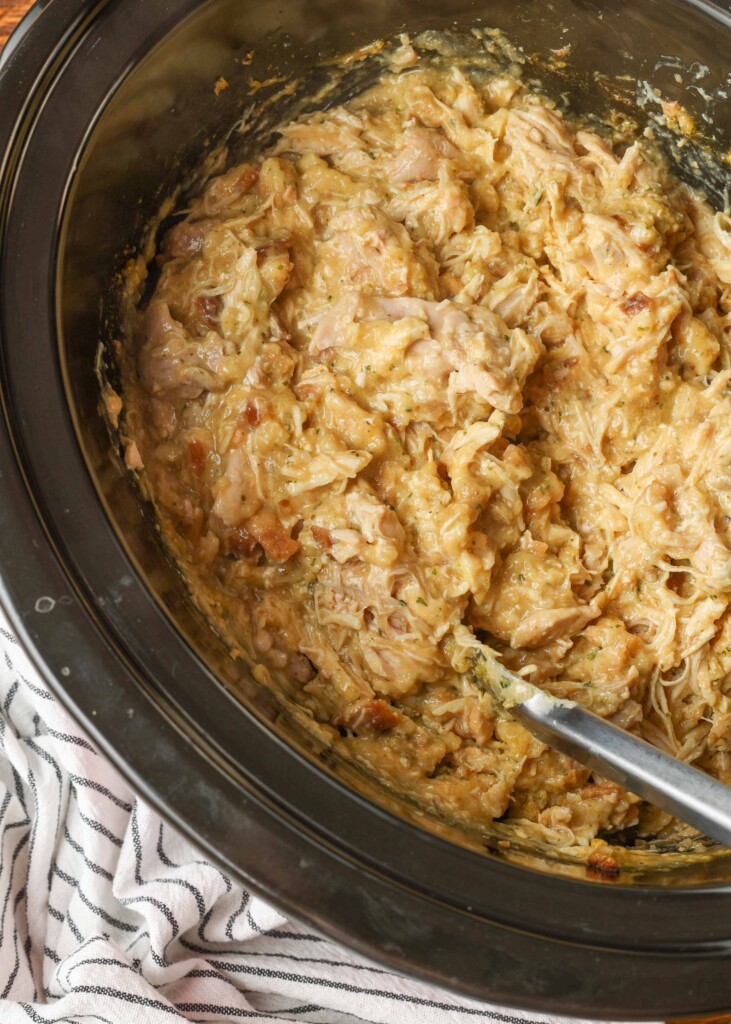 cooked chicken pulled apart in crockpot