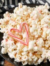 peppermint chocolate popcorn in black bowl with striped towel