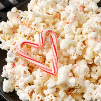 peppermint chocolate popcorn in black bowl with striped towel