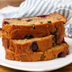 slices of banana bread on plate with striped towel