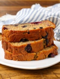 slices of banana bread on plate with striped towel