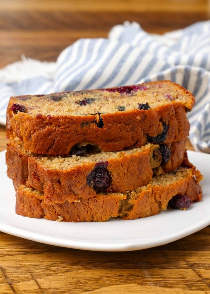 slices of banana bread on plate with striped towel