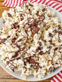 chocolate drizzled popcorn on a pan